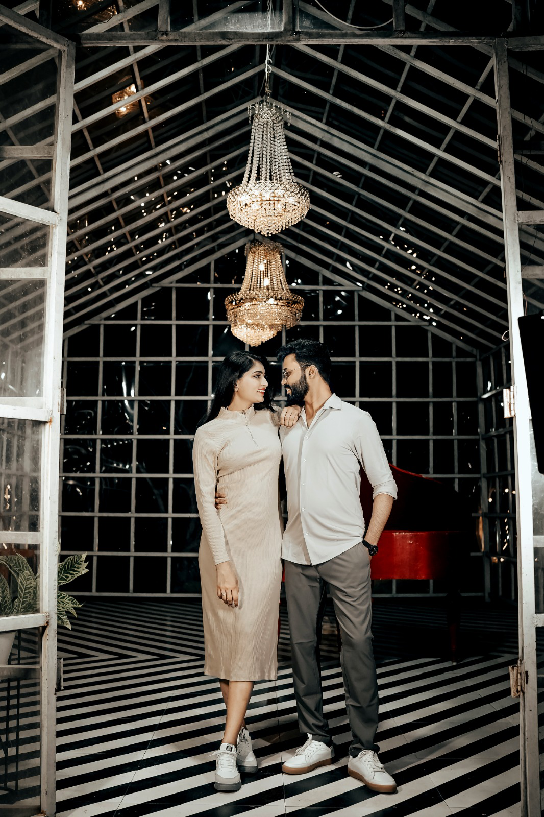 Elegant couple beneath a chandelier