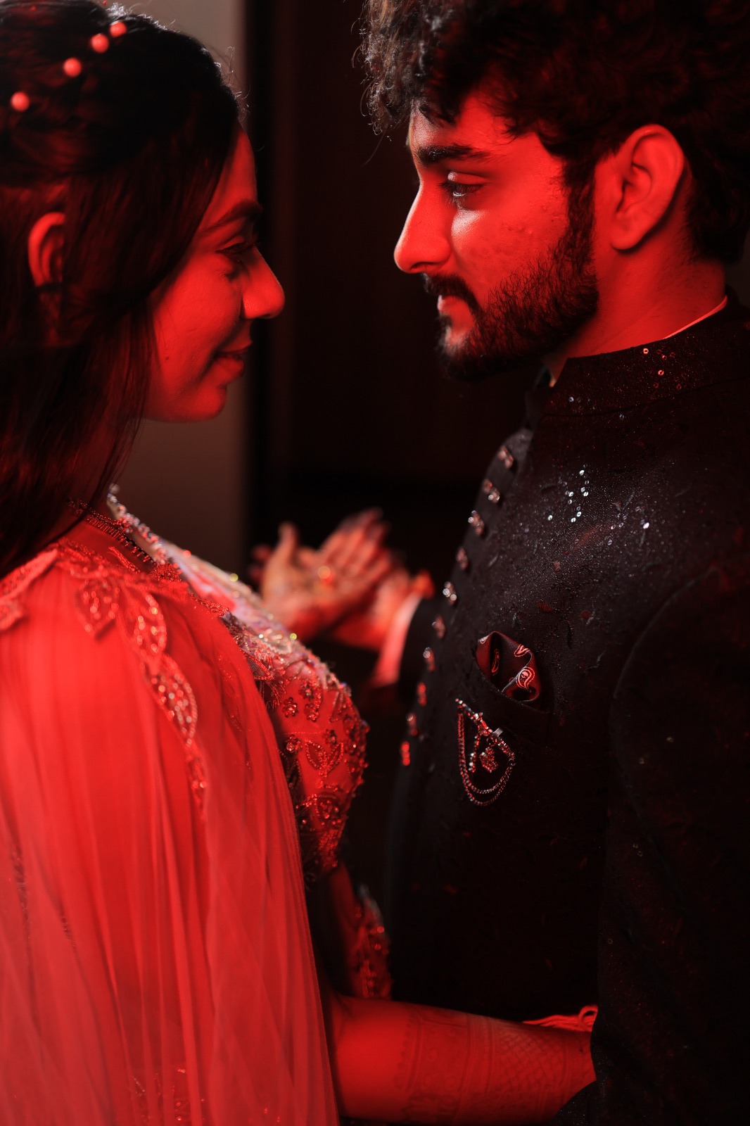 Couple photographed in dramatic red light at night